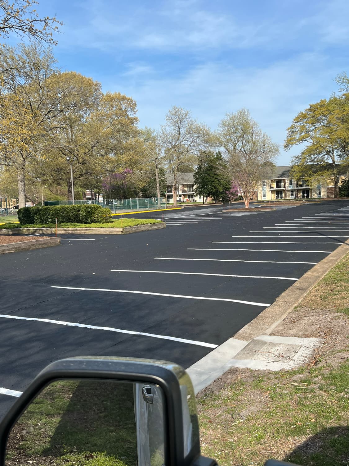 Sealcoating progress shot — All American Paving crew