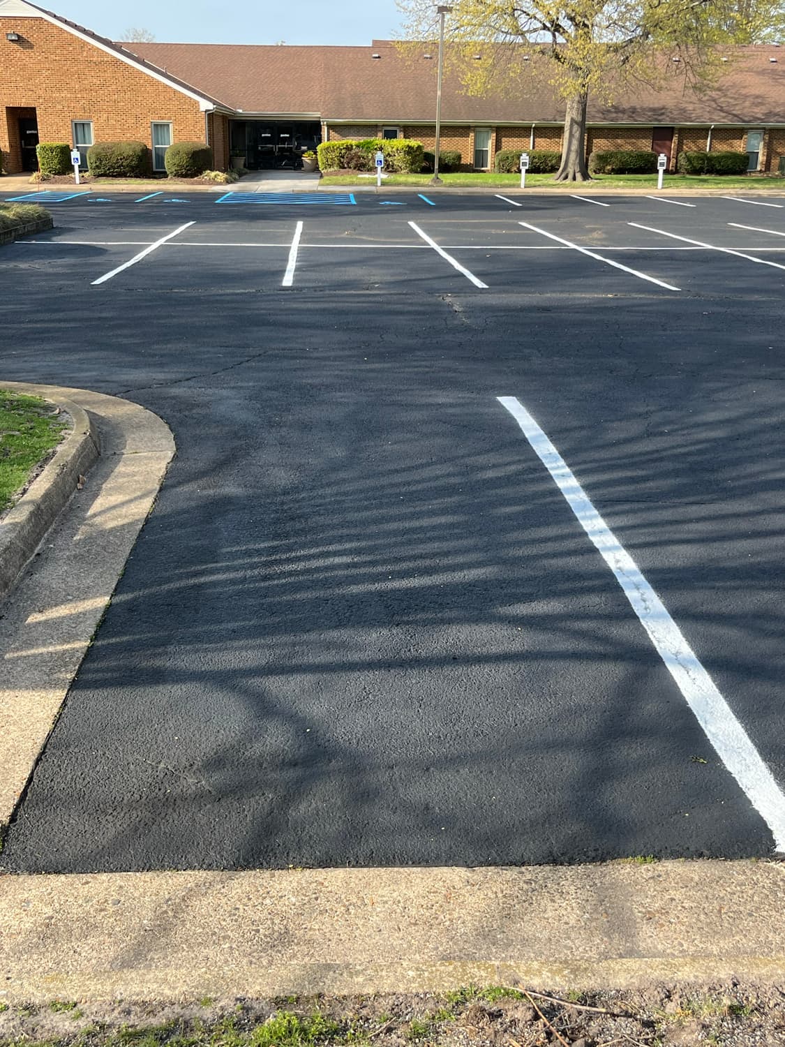 Sealcoating spray-down on commercial pavement