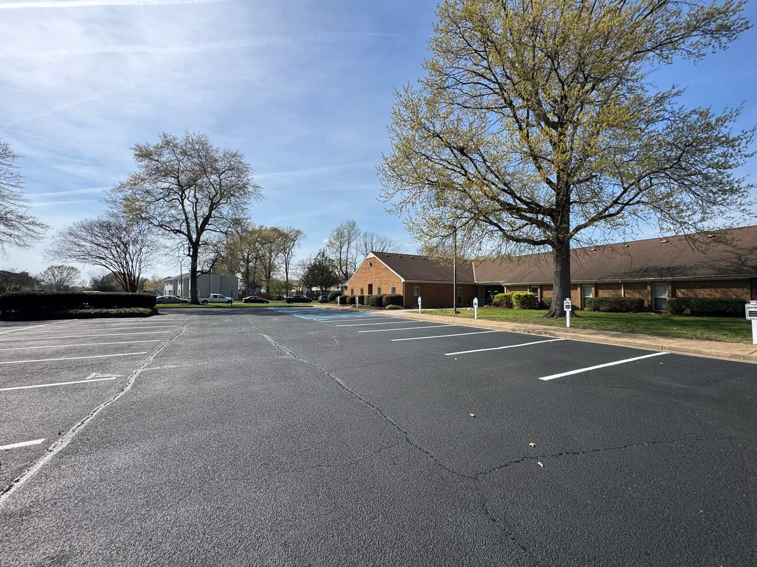 Sealcoating crew finishing a commercial lot
